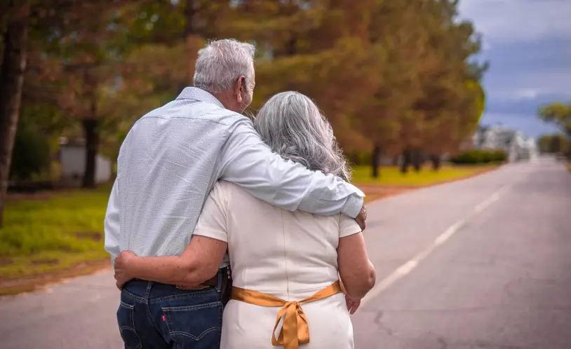 Retired couple walking down a country road