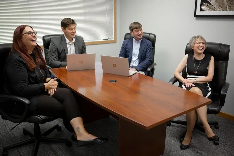 Wright team laughing during a conference